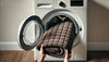 An image of a man loading a washing machine with a cooling blanket