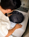 An image of a person washing their pillowcase