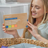 An image of a woman holding up laundry sheets